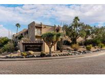 Exterior view of Carefree Terrace, showcasing the building's architecture and landscaping at 7402 E Carefree Dr # 113, Carefree, AZ 85377