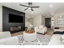 Bright living room features a modern fireplace and stylish furnishings at 10896 E Sahuaro Dr, Scottsdale, AZ 85259
