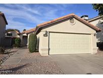 Single-story home with a two-car garage and desert landscaping at 1314 E Helena Dr, Phoenix, AZ 85022