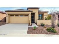 Single-story home with two-car garage and desert landscaping at 17937 W Cedarwood Ln, Goodyear, AZ 85338