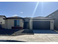 Single-story home with a two-car garage and desert landscaping at 19213 W Missouri Ave, Litchfield Park, AZ 85340