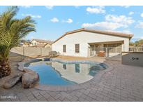 Relaxing kidney-shaped pool in a private backyard setting at 19912 N Toledo Ave, Maricopa, AZ 85138