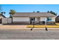 Single-story home with a well-maintained front yard and gated entrance at 2745 W Michelle Dr, Phoenix, AZ 85053