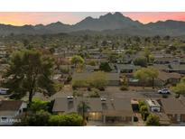 Aerial view of a house with a pool, showcasing mountain views and surrounding neighborhood at 2856 E Cochise Rd, Phoenix, AZ 85028