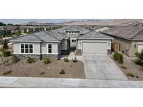 Single-story home with gray exterior, stone accents, and a two-car garage at 5116 N 185Th Ave, Litchfield Park, AZ 85340