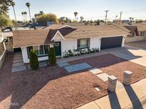 Charming single story home with a well-manicured front yard at 8213 E Mitchell Dr, Scottsdale, AZ 85251