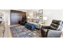 Bright living room with a sofa, armchairs, and a stylish rug at 10529 W Palmeras Dr, Sun City, AZ 85373