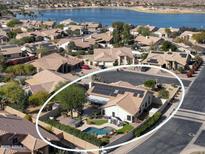 Aerial view of house with pool, spa, and solar panels; desirable location at 10724 S Mustang Dr, Goodyear, AZ 85338