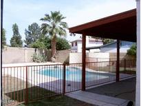 Inviting backyard pool with a metal fence and covered patio at 11051 N 53Rd Ave, Glendale, AZ 85304