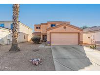 Two-story house with a large garage and desert landscaping at 12305 W Flores Dr, El Mirage, AZ 85335