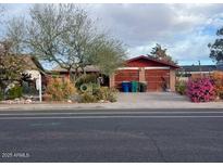 Charming single-story home with a well-manicured front yard and attached garage at 1232 E Mclellan Rd, Mesa, AZ 85203