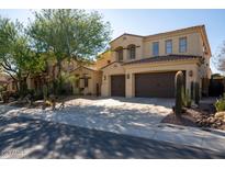 Two-story house with three-car garage and desert landscaping at 13347 W Via Caballo Blanco --, Peoria, AZ 85383