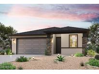 One-story home with gray siding, stone accents, and a two-car garage at 18228 W Daley Ln, Surprise, AZ 85387