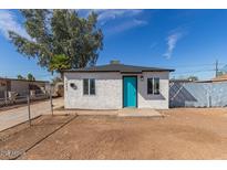 Newly renovated single story home with teal door at 1830 N 37Th Dr, Phoenix, AZ 85009