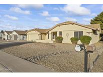 Ranch style home with a two-car garage and nicely landscaped yard at 19806 N Stardust Blvd, Sun City West, AZ 85375