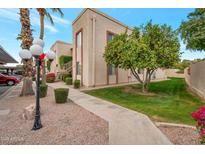 Attractive exterior of condo building with landscaping and walkway at 205 N 74Th St # 159, Mesa, AZ 85207