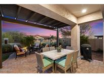 Covered patio with seating area, dining table, and grill at 2129 N Atwood --, Mesa, AZ 85207