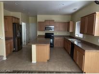 Spacious kitchen featuring an island, stainless steel appliances, and ample cabinetry at 2431 N 83Rd Dr, Phoenix, AZ 85037