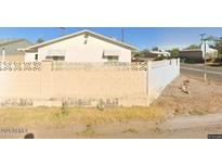 Ranch style home with a block wall and a small yard at 297 Peretz Cir, Morristown, AZ 85342