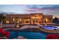 Stunning desert home with pool and spa at dusk at 39005 N 11Th Ave, Phoenix, AZ 85086