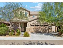 Two-story house with a three-car garage and landscaped front yard at 4026 E Madre Del Oro Dr, Cave Creek, AZ 85331