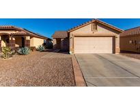 One-story house with a two-car garage and desert landscaping at 521 W Jardin Loop, Casa Grande, AZ 85122