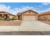 Charming single story home featuring a two car garage and desert landscaping at 521 W Jardin Loop, Casa Grande, AZ 85122