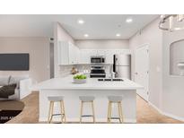 Modern kitchen with white cabinets, quartz countertops, and island at 6920 E 4Th St # 103, Scottsdale, AZ 85251