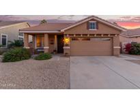 Single-story home with a two-car garage and desert landscaping at 6931 W Blackhawk Dr, Glendale, AZ 85308