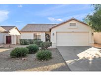 Single-story home with a two-car garage and well-manicured landscaping at 10647 W Ross Ave, Peoria, AZ 85382
