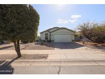 One-story house with a green front door and a two-car garage at 15977 W Latham St, Goodyear, AZ 85338