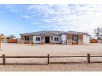 Single-story home with a large front yard and neutral color scheme at 22414 W Meade Ln, Buckeye, AZ 85326