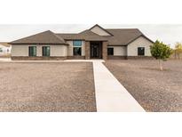 Single story home with stone accents and a landscaped yard at 34949 N Donald Way, San Tan Valley, AZ 85140