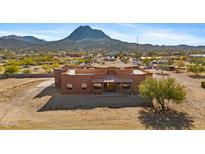 Aerial view of a stucco home with mountain views and desert landscape at 48412 N 31St Ave, New River, AZ 85087