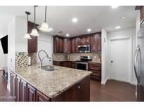 Spacious kitchen with granite countertops and dark wood cabinets at 5144 E Colby St, Mesa, AZ 85205
