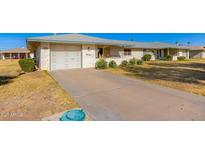 Ranch-style home with a carport and spacious yard at 10012 W Sandstone Dr, Sun City, AZ 85351