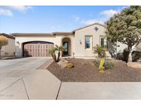 Single-story home with brown garage door, landscaping, and desert plants at 122 E Orange Blossom Path, Queen Creek, AZ 85140