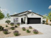 Single-story home with a two-car garage and desert landscaping at 1393 W Inca Dr, Coolidge, AZ 85128