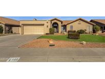 Tan stucco house with tile roof, two-car garage, and nicely landscaped yard at 160 W La Vieve Ln, Tempe, AZ 85284