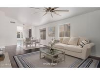 Virtually staged living area featuring hardwood floors, a dining area, and ample natural light at 16019 S 40Th Way, Phoenix, AZ 85048