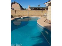 Inviting kidney-shaped pool, perfect for relaxation at 1911 W Kimberly Way, Phoenix, AZ 85027