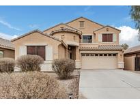 Two-story house with tan exterior, attached garage, and landscaping at 20475 N Herbert Ave, Maricopa, AZ 85138