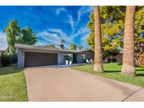 Contemporary home with gray exterior, two-car garage, and landscaped yard at 2942 N 81St Pl, Scottsdale, AZ 85251