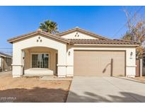 Newly constructed home with a two-car garage and neutral color palette at 414 E Eason Ave, Buckeye, AZ 85326