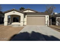 Newly constructed single-story home with attached garage and landscaped front yard at 414 E Eason Ave, Buckeye, AZ 85326