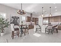 Modern kitchen with breakfast bar and custom cabinetry at 5645 N Crow Dr, Eloy, AZ 85131