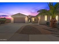 Beautiful desert home exterior at sunset, featuring a welcoming entryway and landscaping at 6616 S Bridal Vail Dr, Gilbert, AZ 85298