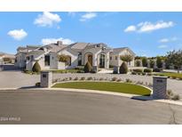 Stunning curb appeal! This home features a large front yard, driveway, and modern design at 7483 S Loback Ct, Queen Creek, AZ 85142