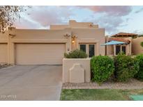 Tan stucco exterior with two-car garage and landscaped front yard at 7756 E San Miguel Ave, Scottsdale, AZ 85250