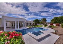 Stunning pool and spa with covered patio, perfect for outdoor entertaining at 11124 E Del Timbre Dr, Scottsdale, AZ 85259